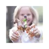 A young girl is holding a toy horse and rider in front of her. Voir les images du produit