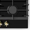 A close-up, top-down view of a black gas stovetop with gold control knobs. Náhľad obrázku produktu