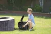 A man is setting up an inflatable hot tub in a grassy backyard. Náhľad obrázku produktu