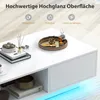 A white high-gloss coffee table with decorative items and ambient LED lighting. Voir les images du produit