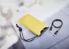 A yellow power bank with a USB-C cable on a light gray surface. Voir les images du produit