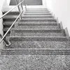 A close-up view of a granite staircase with metal railings. Produktbild-Vorschau