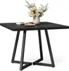 A square black table with a vase of flowers and a book on it, set against a white background. Náhľad obrázku produktu