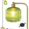 A close-up view of a green glass floor lamp with a gold finish. Anteprima dell’immagine prodotto