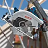 A circular saw is attached to scaffolding at a construction site. Podgląd zdjęcia produktu
