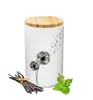 A white ceramic canister with a bamboo lid, decorated with a dandelion motif. A bundle of vanilla beans and a sprig of mint are placed in front of the canister. Produktbild-Vorschau