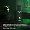A person wearing headphones is shown in a dimly lit room with green ambient lighting, suggesting a gaming or entertainment setup. Produktbild-Vorschau