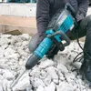 A person is using a demolition hammer to break up concrete rubble. Anteprima dell’immagine prodotto