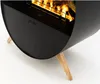 A close-up shot of a modern black fireplace with wooden legs, showing the flames inside. Náhled obrázku produktu