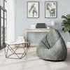 A modern living room with a bean bag chair, a desk, and artwork. Náhled obrázku produktu