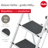 A close-up view of a white stepladder with black steps, featuring marketing text and logos. Podgląd zdjęcia produktu