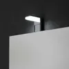 A close-up shot of a modern LED light fixture mounted above a mirror. Anteprima dell’immagine prodotto