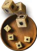 Several dice are scattered in and around a wooden bowl. Podgląd zdjęcia produktu