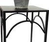 A close-up view of a black metal plant stand with decorative scrollwork. Anteprima dell’immagine prodotto