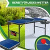 A split image showing a ping pong table in a sunny garden on one side and in a snowy environment on the other. A folded ping pong table is shown in the foreground. Produktbild-Vorschau
