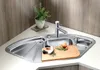 A corner kitchen sink with a cutting board, knife, onion, and rosemary. Podgląd zdjęcia produktu
