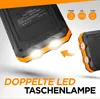 A close-up marketing image of a solar power bank with its LED lights illuminated, and a smaller inset image of another solar power bank. Produktbild-Vorschau
