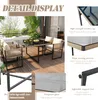 A patio dining set with a glass-top table and four chairs, displayed on a wooden deck with greenery in the background. Produktbild-Vorschau