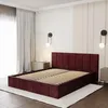 A bedroom scene featuring a burgundy upholstered bed frame with a slatted base, set against a wall with patterned wallpaper and two modern wall sconces. Produktbild-Vorschau