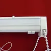A close-up view of the top mechanism of a white roller blind, showing the cassette, the bead chain, and a white cord. Produktbild-Vorschau