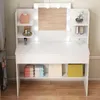 A white vanity table with a lighted mirror and shelves, displaying various cosmetic items and storage bags. Náhled obrázku produktu