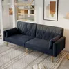 A dark gray sofa with diamond tufting is placed on a patterned rug in a well-lit room. A framed abstract artwork hangs on the wall behind it, and a lamp is visible to the right. Voir les images du produit
