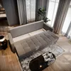 A modern living room with a gray sofa, coffee table, and curtains. Produktbild-Vorschau