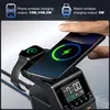 A hand is shown placing a smartphone on a wireless charging station that also charges a smartwatch. The charging station has a digital clock display. Produktbild-Vorschau
