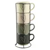 A set of four stacked mugs with heart designs on a black metal stand. Náhled obrázku produktu