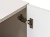 A close-up view of a cabinet hinge connecting a white cabinet door to the cabinet frame. Náhled obrázku produktu