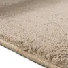 A close-up view of a beige rug with a textured surface and a bound edge. Anteprima dell’immagine prodotto