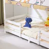 A close-up view of a white wooden bunk bed with a blue dinosaur toy and a yellow duck toy on the lower mattress. Anteprima dell’immagine prodotto