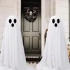 Two ghost decorations stand on a porch in front of a black door decorated with a Halloween wreath. Produktbild-Vorschau