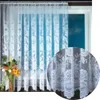 A white lace curtain with a floral pattern is shown hanging in a window. A close-up inset shows a detailed view of the lace pattern. Produktbild-Vorschau