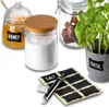 A collection of kitchen storage jars and a potted herb, with chalk labels and a marker. Produktbild-Vorschau
