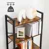 Close-up of a tall, industrial-style bookshelf with wooden shelves and black metal frame, decorated with books and vases. Produktbild-Vorschau