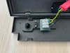 Close-up view of the internal components of a dark gray outdoor LED wall light, showing wiring and a sensor. Anteprima dell’immagine prodotto