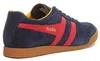 A side view of a blue Gola sneaker with red stripes and a brown sole. Náhled obrázku produktu