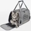 A cat is sitting inside a gray pet carrier bag. Podgląd zdjęcia produktu