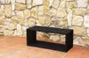 A black metal bench sits on a terracotta tiled patio in front of a stone wall. Anteprima dell’immagine prodotto