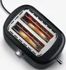 Close-up view of a black toaster with two slices of bread toasting inside. Náhled obrázku produktu