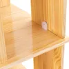 A close-up view of a wooden shelf with a small white plastic bracket attached to the side of a vertical support. Podgląd zdjęcia produktu