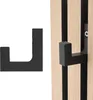 A black hook is shown next to a wooden acoustic panel with black felt. Produktbild-Vorschau