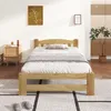 A bedroom with a wooden bed frame and bedding. Anteprima dell’immagine prodotto