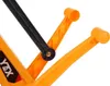 A close-up view of parts of an orange and black toy vehicle. Náhľad obrázku produktu