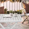 A white folding table with a book and a cup of coffee on a balcony overlooking water. Anteprima dell’immagine prodotto