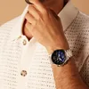 A man wearing a watch and a knitted shirt. Voir les images du produit