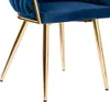 Close-up of the legs and lower part of a blue velvet chair with gold metal legs. Náhled obrázku produktu