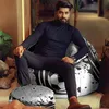 A man is sitting on a bean bag chair with a football design, with a matching ottoman in front of him. The setting appears to be a modern living room or lounge area. Voir les images du produit