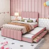 A pink upholstered bed with a pull-out trundle bed and storage drawers, set in a child's bedroom with a wardrobe and decorative wall panels.